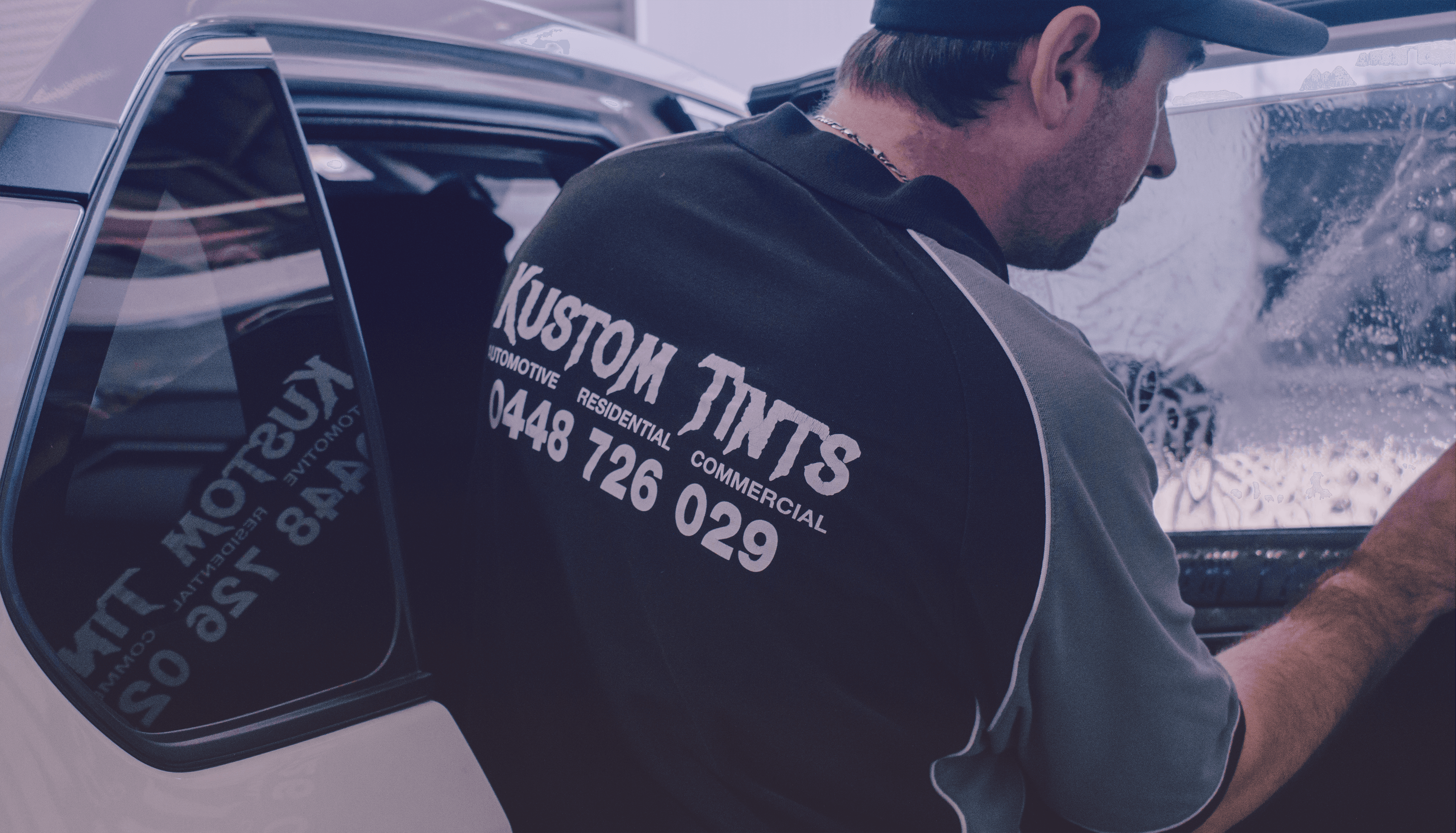 Kustom Tints worker installing tint